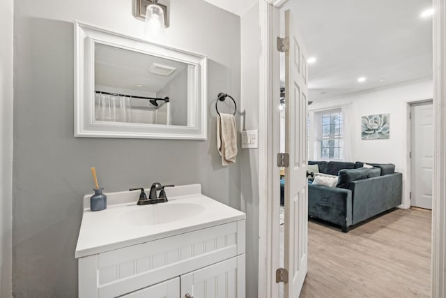 bathroom featuring hardwood / wood-style flooring, vanity, and curtained shower