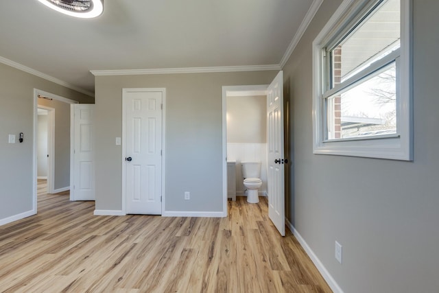 unfurnished bedroom with light hardwood / wood-style floors, ensuite bathroom, and crown molding