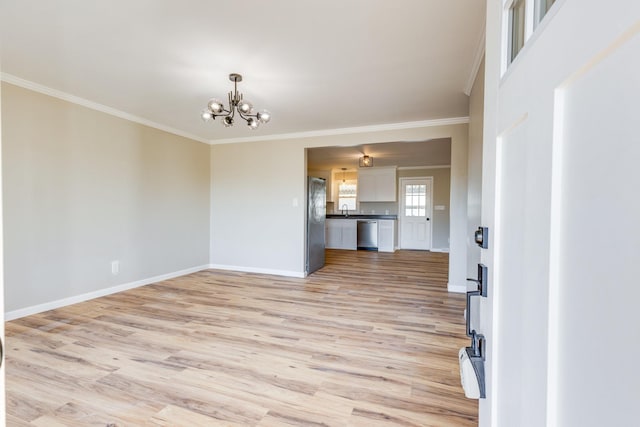 unfurnished living room with an inviting chandelier, ornamental molding, light hardwood / wood-style floors, and sink