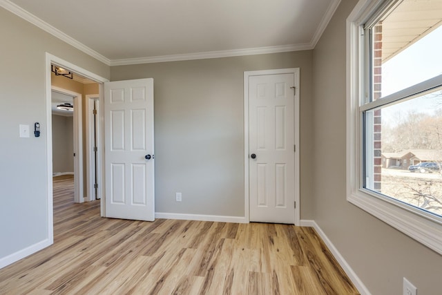 unfurnished bedroom with light wood-type flooring and crown molding