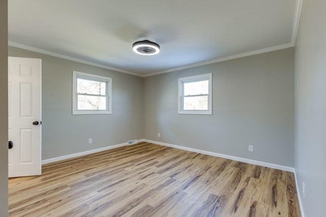 spare room with crown molding and light hardwood / wood-style flooring