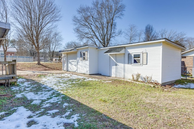 view of side of home with a lawn