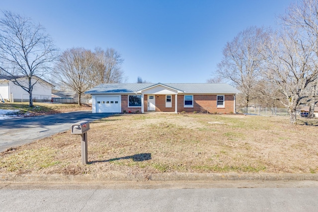 single story home with a front lawn and a garage