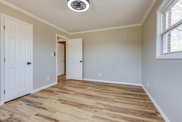 unfurnished bedroom featuring ornamental molding and light wood-type flooring