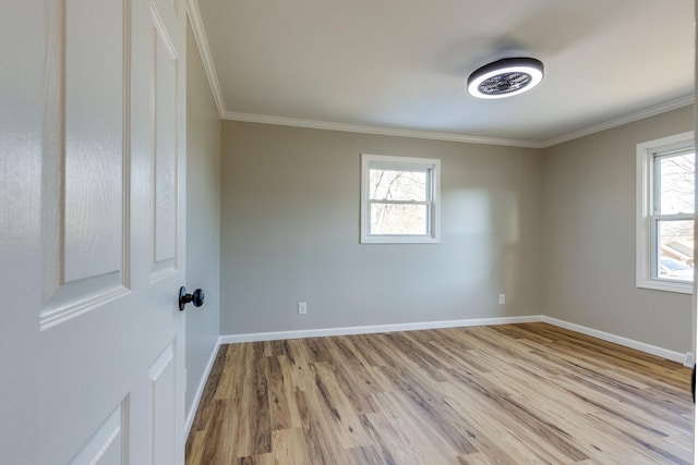 unfurnished room featuring plenty of natural light, light hardwood / wood-style flooring, and crown molding