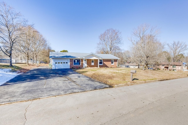 ranch-style home with a front lawn and a garage