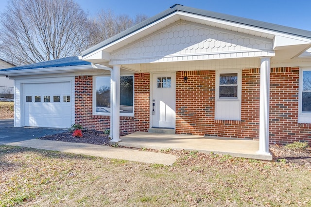 view of front facade featuring covered porch and a garage