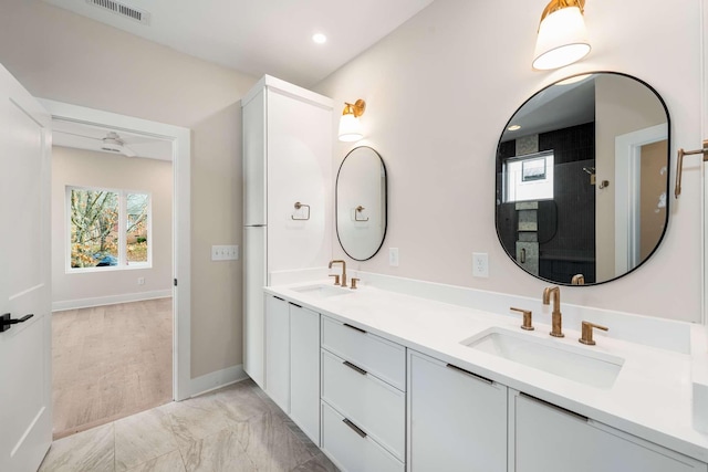 bathroom featuring vanity and tiled shower