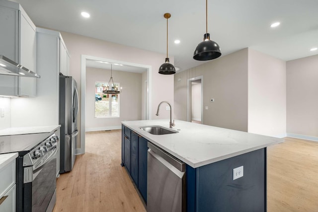 kitchen featuring blue cabinets, sink, light wood-type flooring, appliances with stainless steel finishes, and white cabinetry