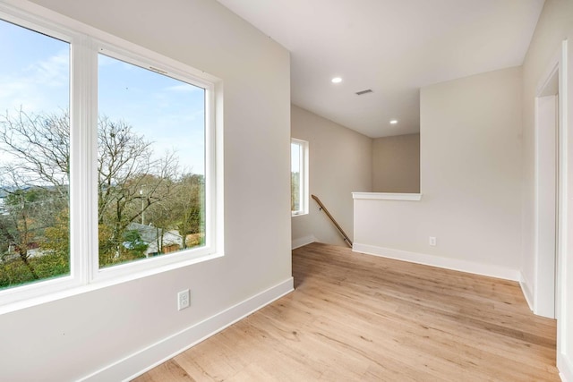 unfurnished room with plenty of natural light and light hardwood / wood-style floors