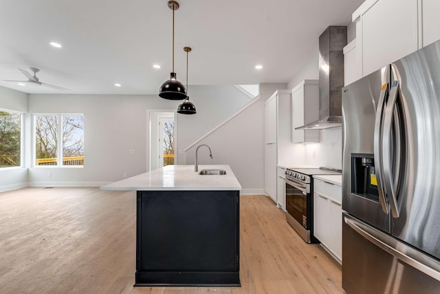 kitchen with decorative light fixtures, white cabinetry, a kitchen island with sink, and appliances with stainless steel finishes