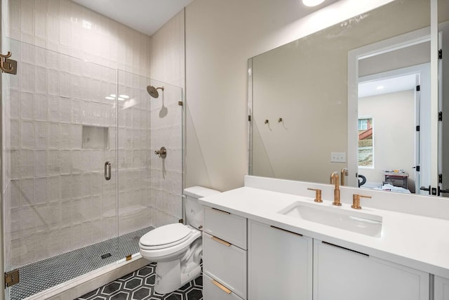 bathroom with tile patterned flooring, vanity, toilet, and an enclosed shower