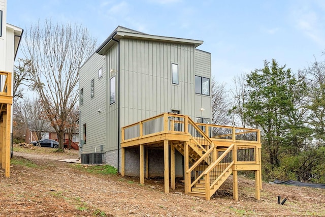 back of house featuring a wooden deck and central AC