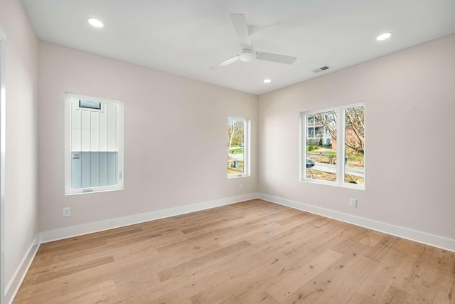 spare room with light wood-type flooring and ceiling fan