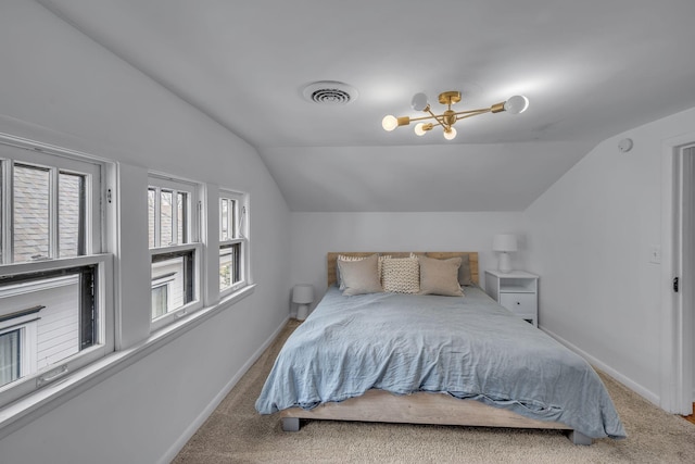 bedroom featuring carpet flooring, multiple windows, and lofted ceiling