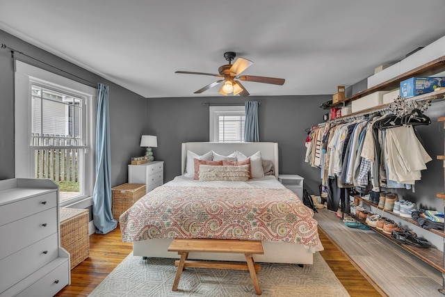 bedroom with ceiling fan and light hardwood / wood-style flooring