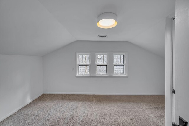 bonus room featuring carpet and lofted ceiling