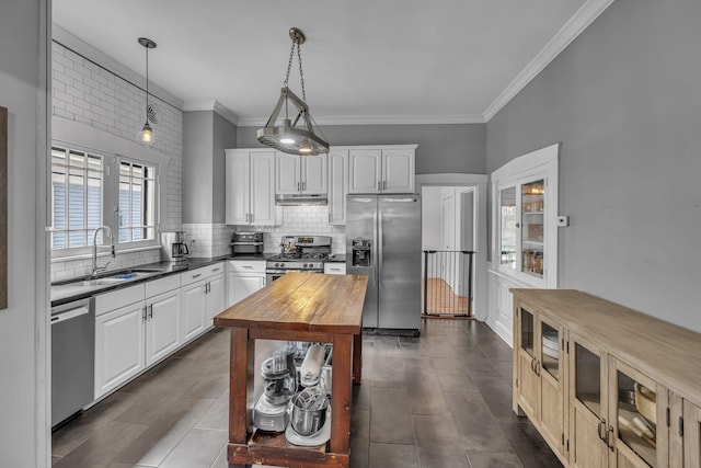 kitchen with white cabinets, decorative light fixtures, a healthy amount of sunlight, and stainless steel appliances