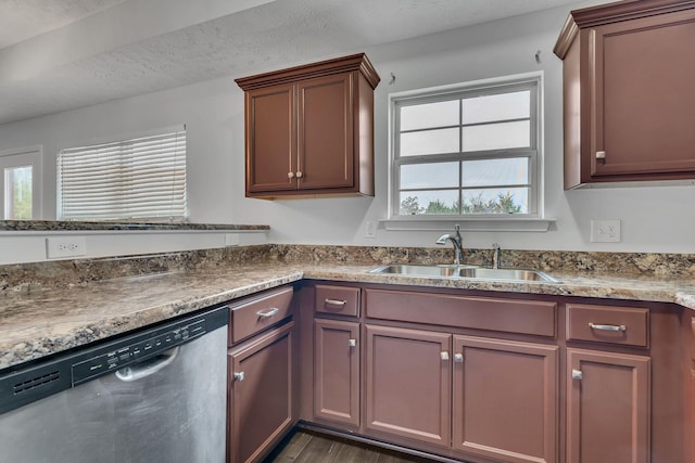 kitchen with a textured ceiling, dishwasher, dark hardwood / wood-style floors, and sink