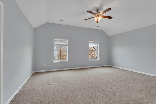 empty room with carpet flooring, ceiling fan, and lofted ceiling