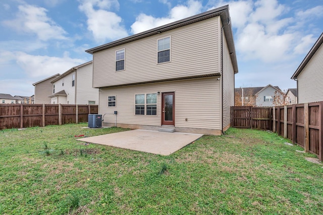 rear view of property featuring a patio area, a yard, and central AC