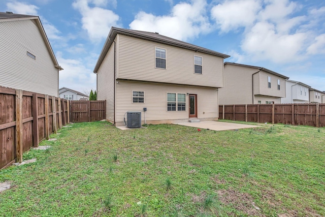 back of property featuring a yard, a patio, and central AC