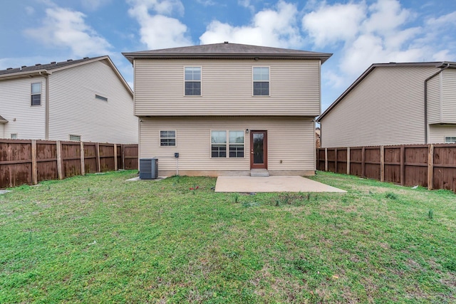 rear view of property with a patio, cooling unit, and a lawn