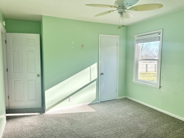 spare room featuring carpet and ceiling fan