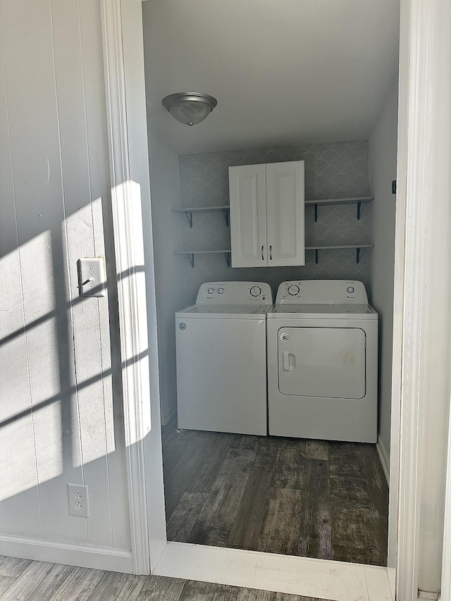 washroom with cabinets, dark hardwood / wood-style floors, and washing machine and dryer