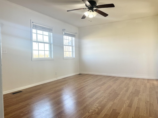 unfurnished room featuring hardwood / wood-style floors and ceiling fan