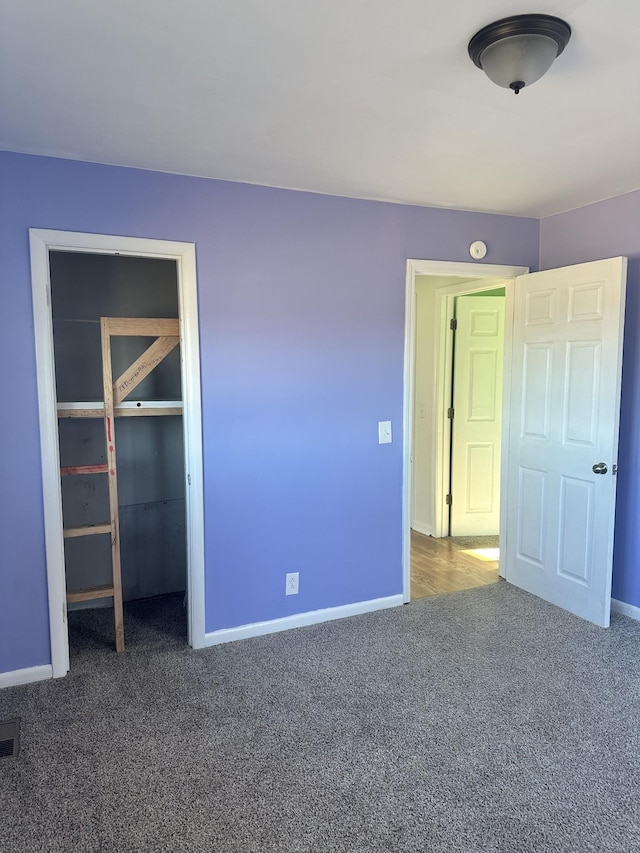 unfurnished bedroom featuring carpet floors and a closet