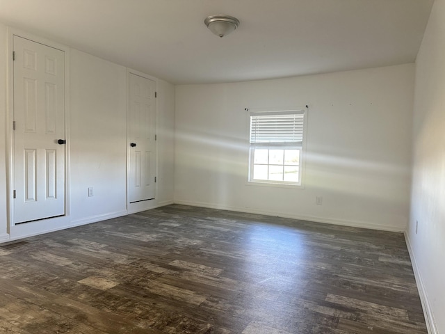 spare room featuring dark hardwood / wood-style floors