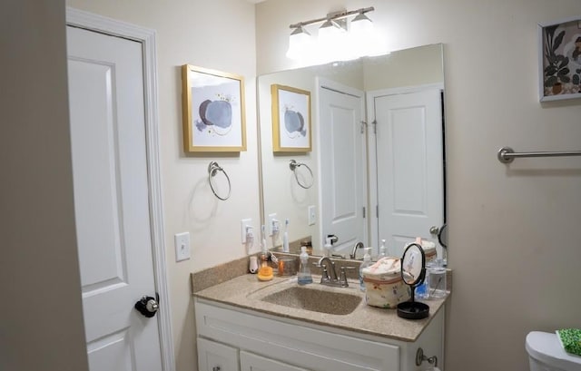 bathroom featuring vanity and toilet