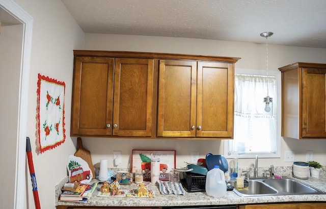 kitchen featuring a textured ceiling and sink