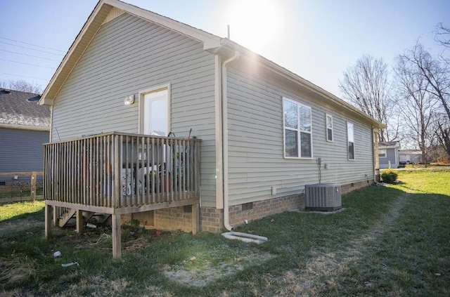 view of property exterior with a yard, central AC, and a wooden deck