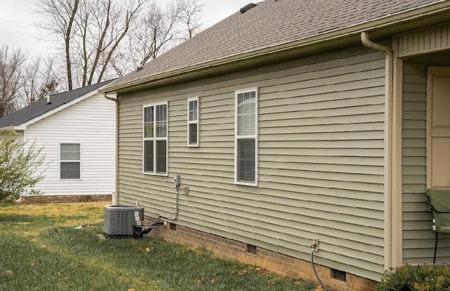 view of property exterior with a yard and cooling unit