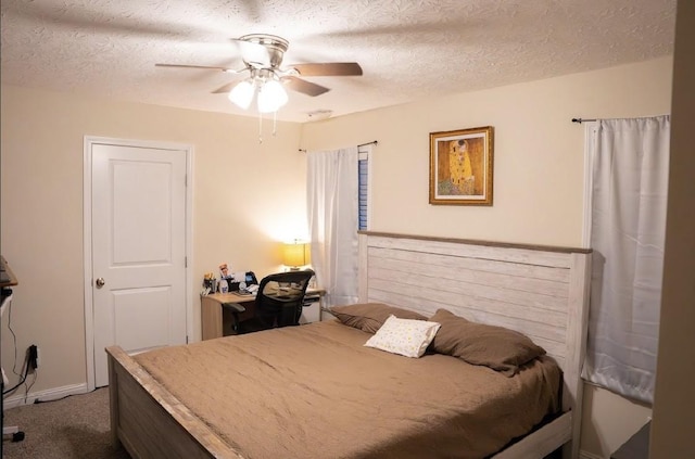 bedroom featuring ceiling fan, carpet, and a textured ceiling