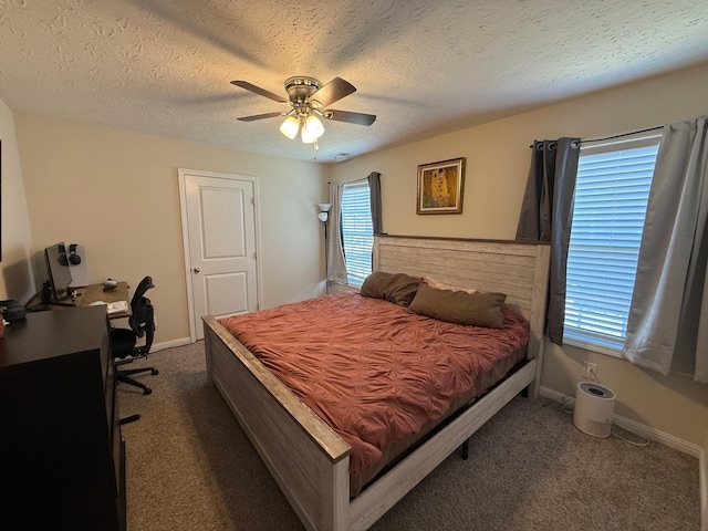 bedroom featuring a textured ceiling, dark colored carpet, ceiling fan, and baseboards
