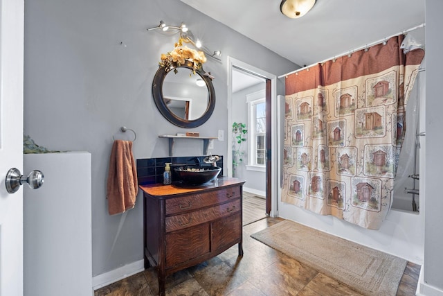 bathroom featuring shower / bath combination with curtain and vanity