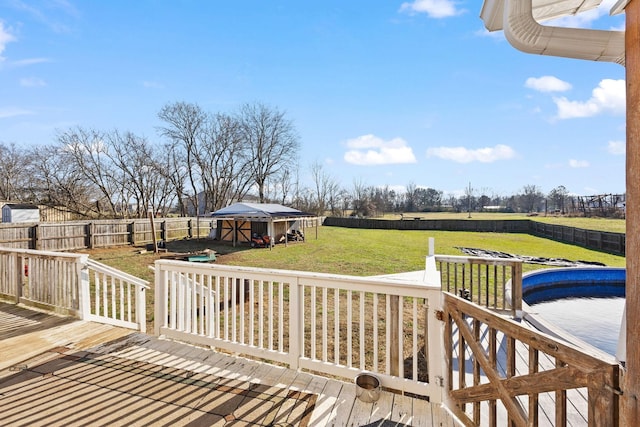 wooden deck featuring a lawn and an outdoor structure