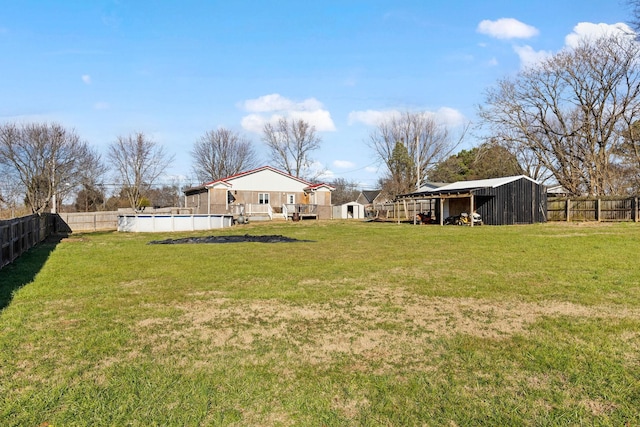 view of yard featuring a pool side deck and a shed