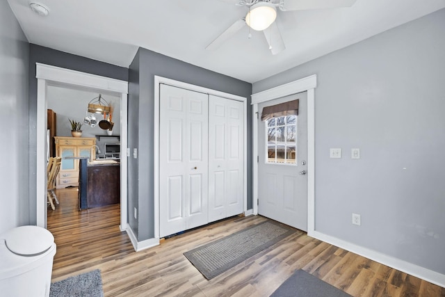 foyer entrance with ceiling fan and hardwood / wood-style flooring