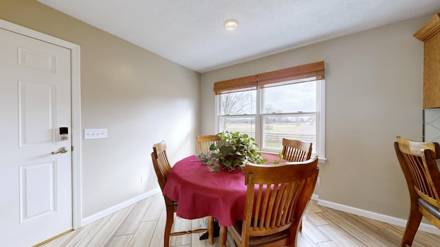 dining space with light hardwood / wood-style floors