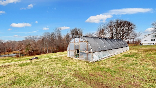 view of outbuilding featuring a lawn