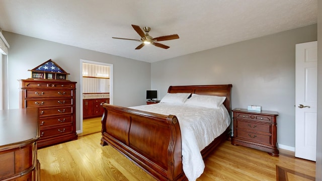 bedroom with ceiling fan, light hardwood / wood-style flooring, and connected bathroom