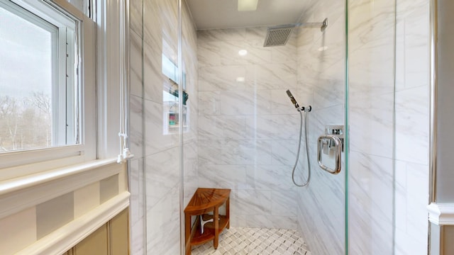 bathroom featuring a shower with shower door