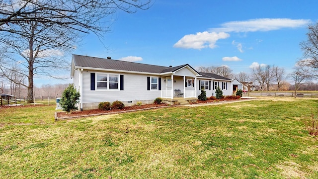 ranch-style house featuring a front yard and covered porch