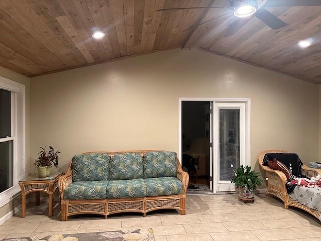 interior space featuring ceiling fan, wood ceiling, vaulted ceiling, and light tile patterned flooring