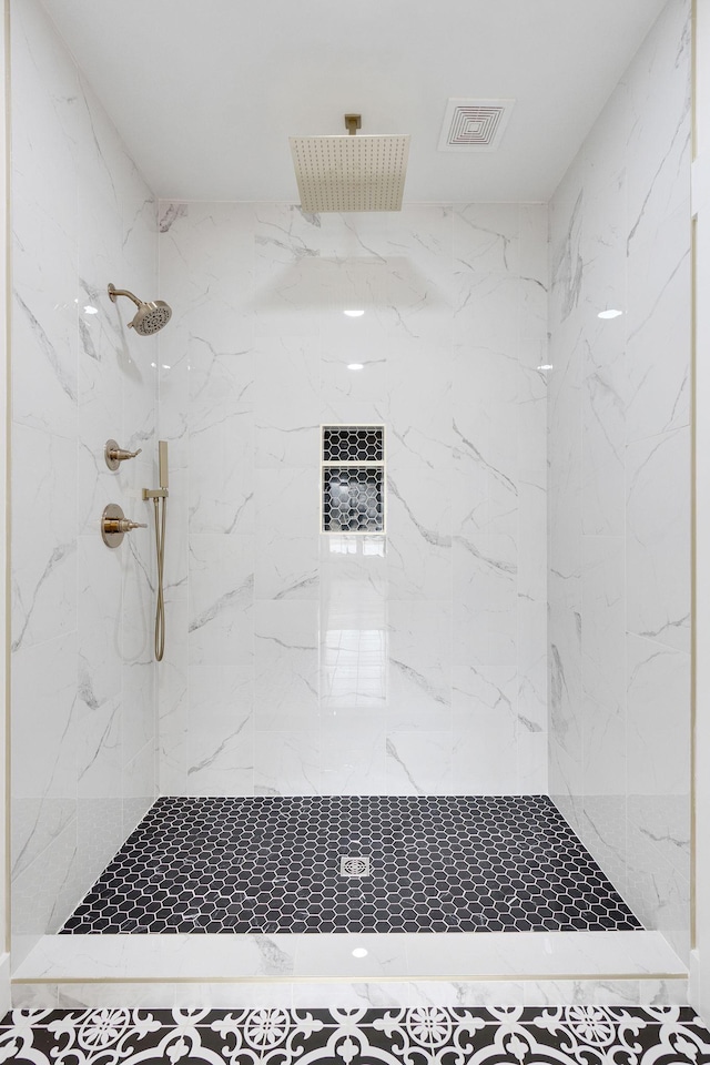 bathroom with a tile shower