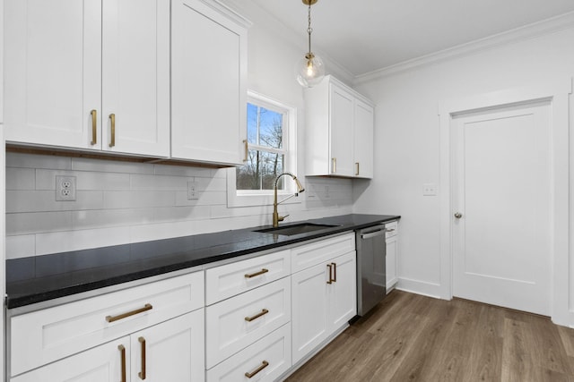 kitchen featuring dark wood-type flooring, white cabinets, sink, stainless steel dishwasher, and decorative backsplash